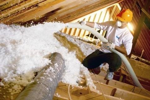 Blown-in insulation being installed in an attic in Columbus.