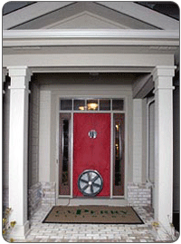 The exterior of a home undergoing a blower door test